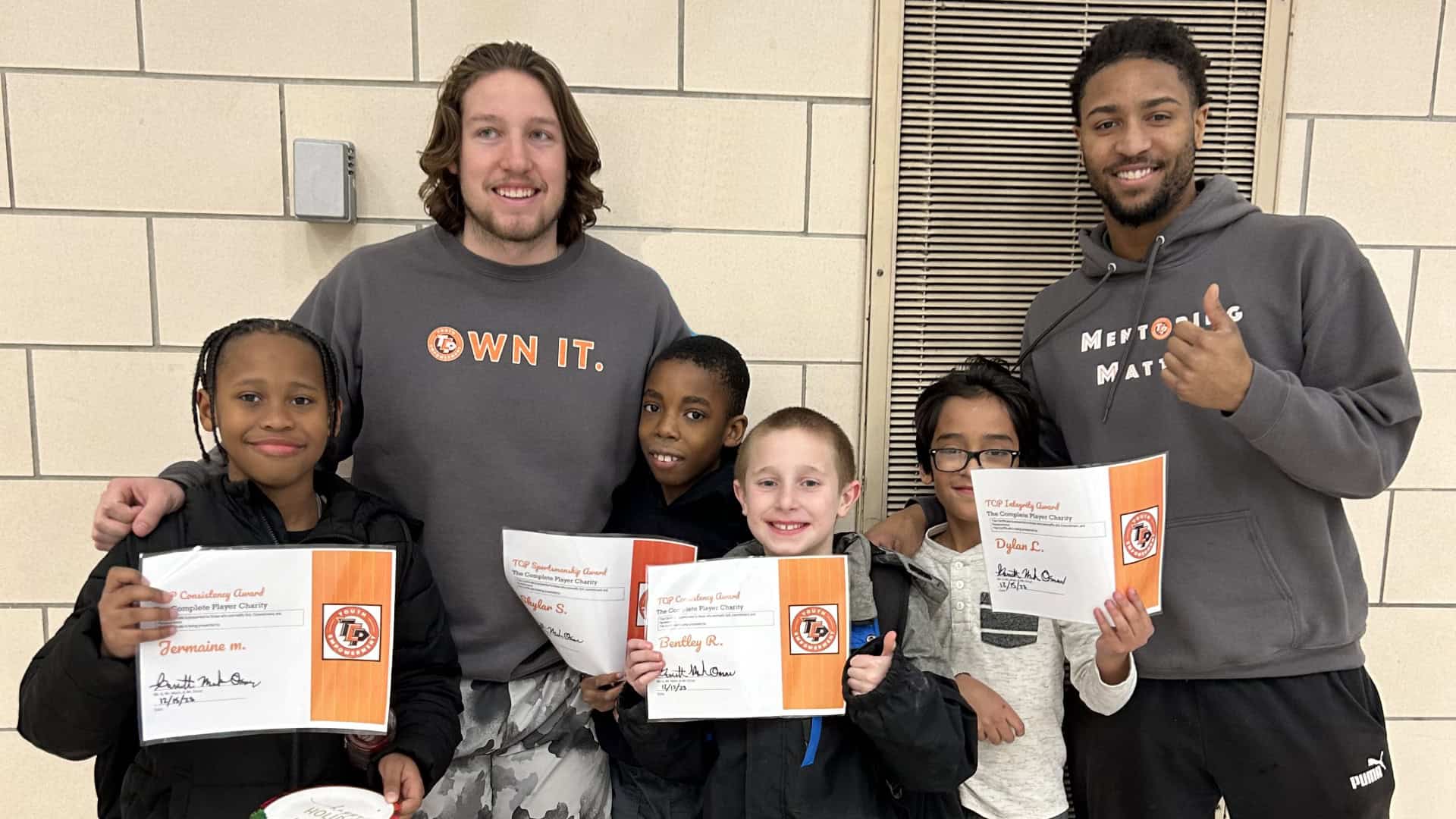 TCP lighting the path to a brighter future Two TCP mentors with four students holding certificates.